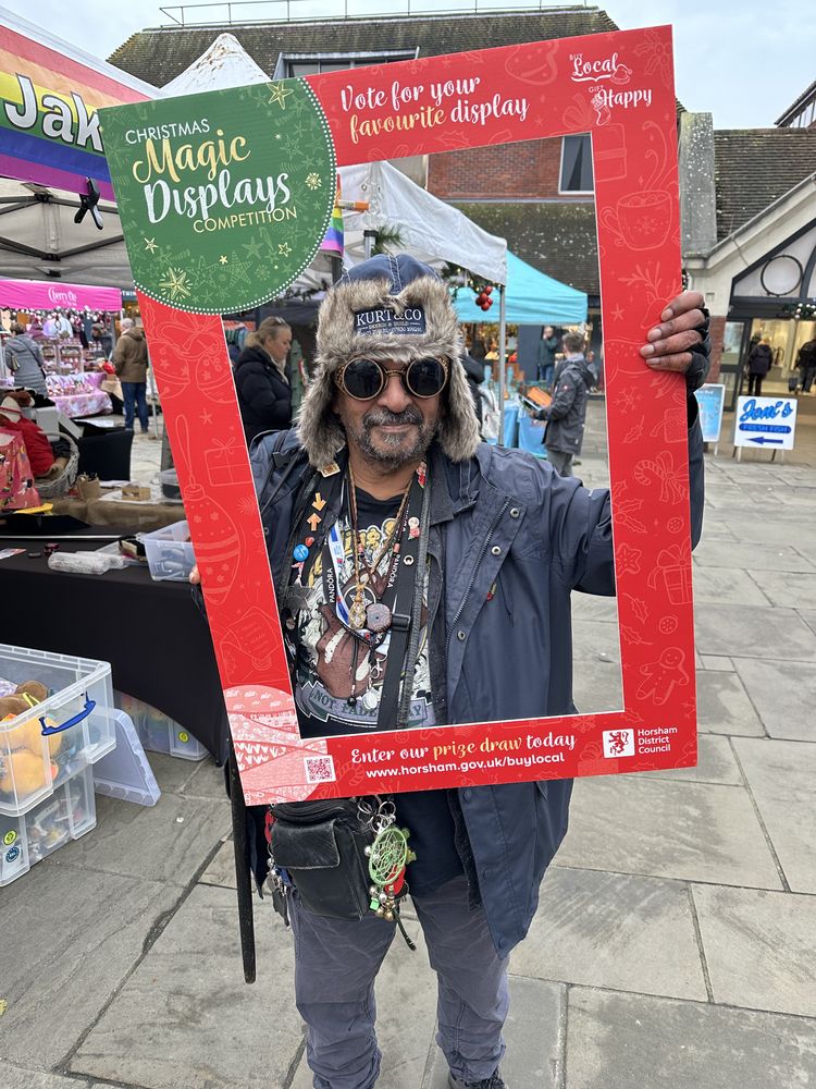 A visitor posing in a Christmas photo frame