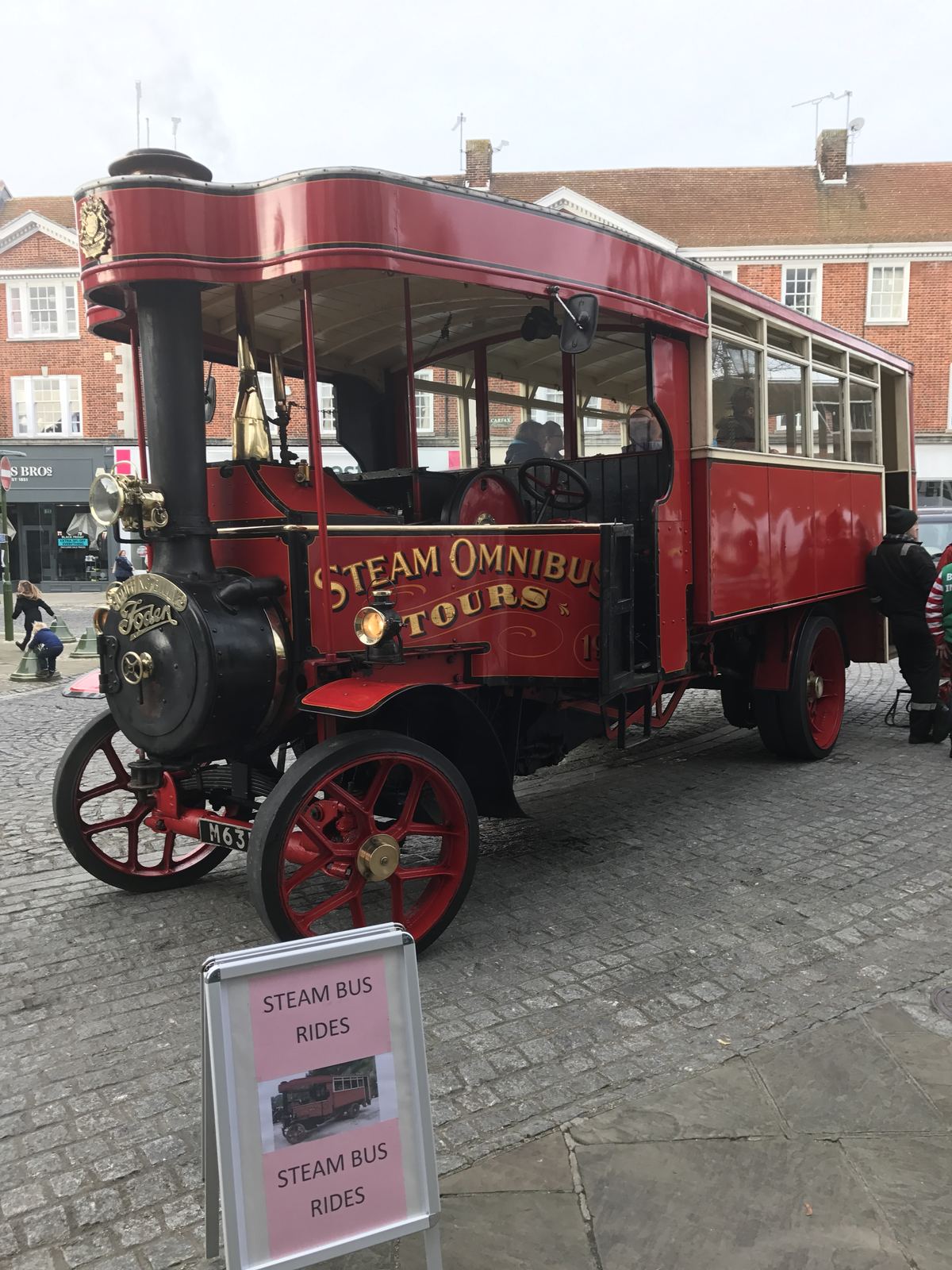A red steam omnibus giving rides in the Carfax