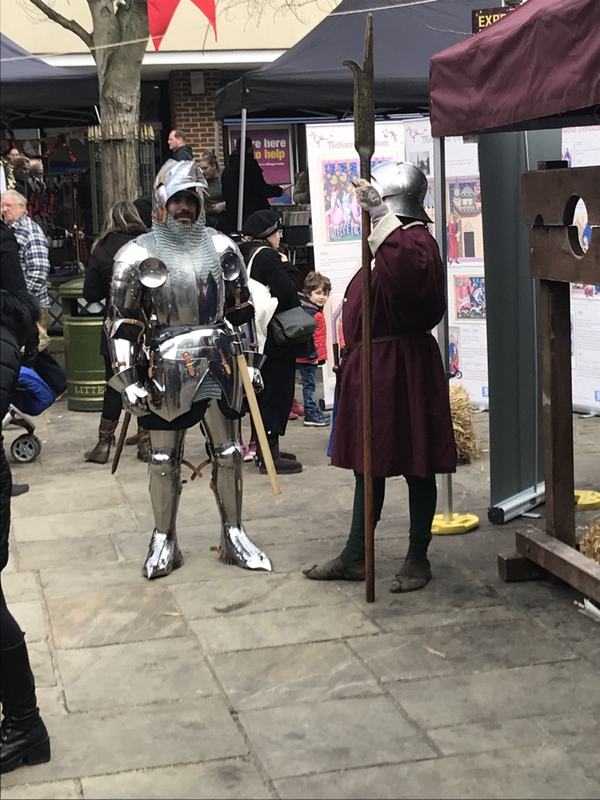 A knight in armour and a soldier with a halberd