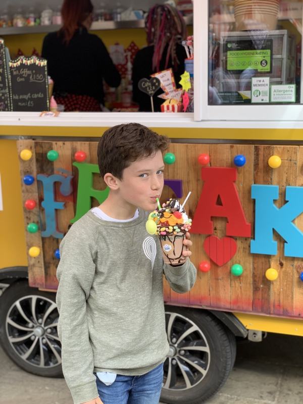 A boy with an enormous milkshake